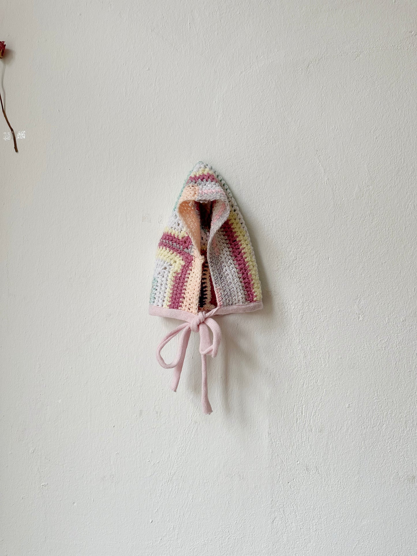 Front view of pastel crocheted bonnet