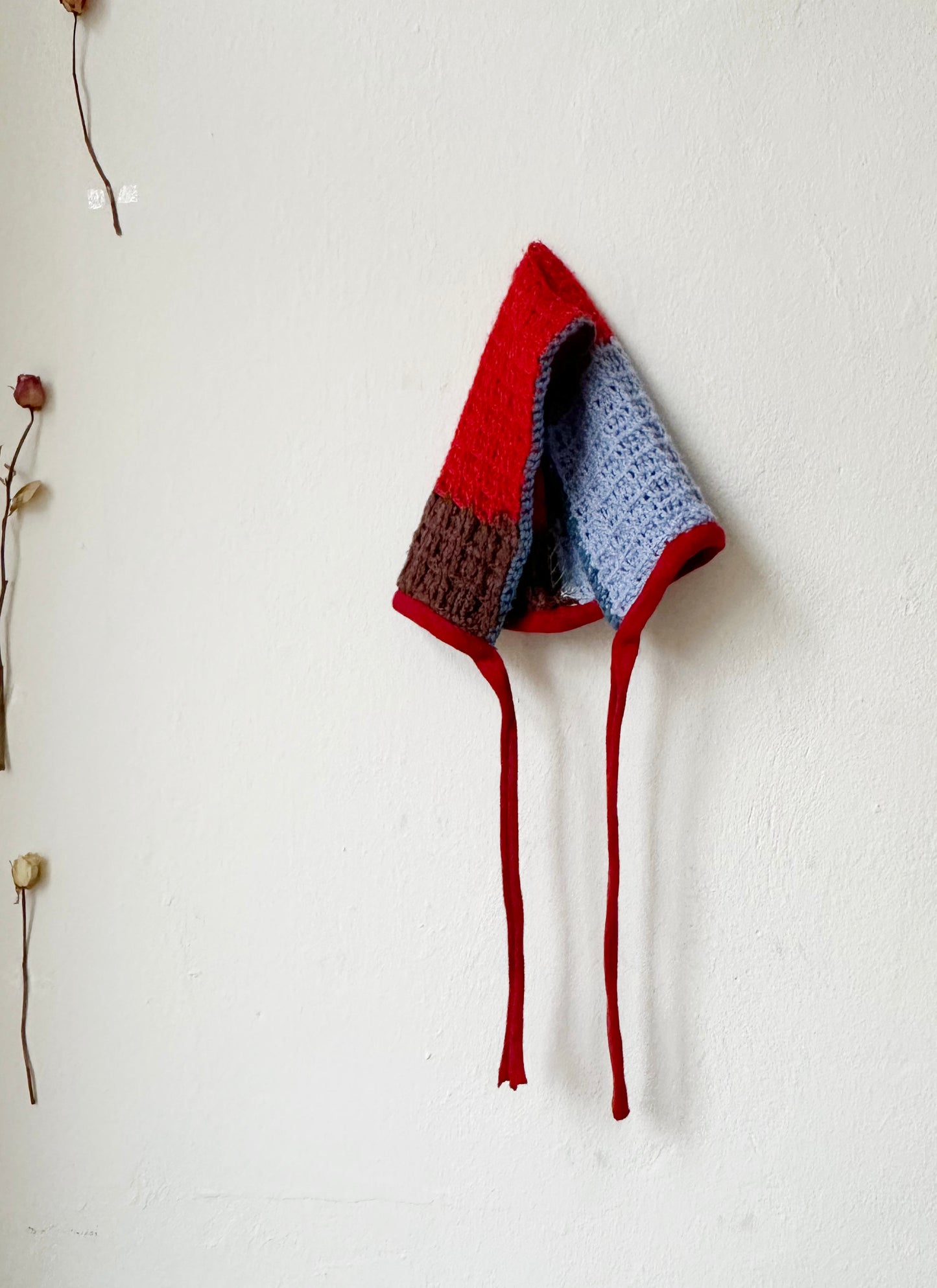 Billie Blanket Cap in red and blue, a vintage-inspired hood-style cap with tie front, perfect for cool weather.