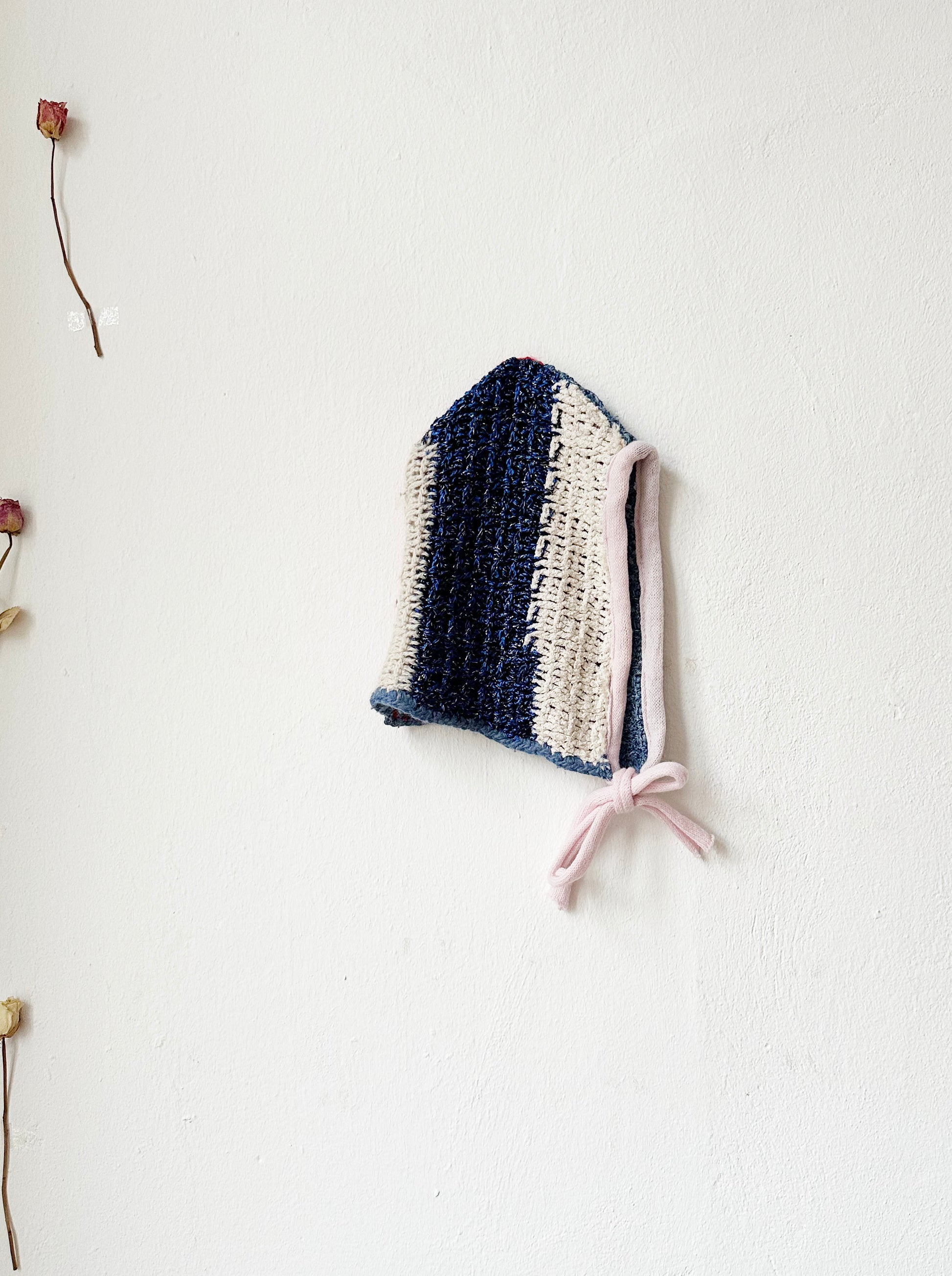 Crochet bonnet with blue lurex shine stripe and pink trim.