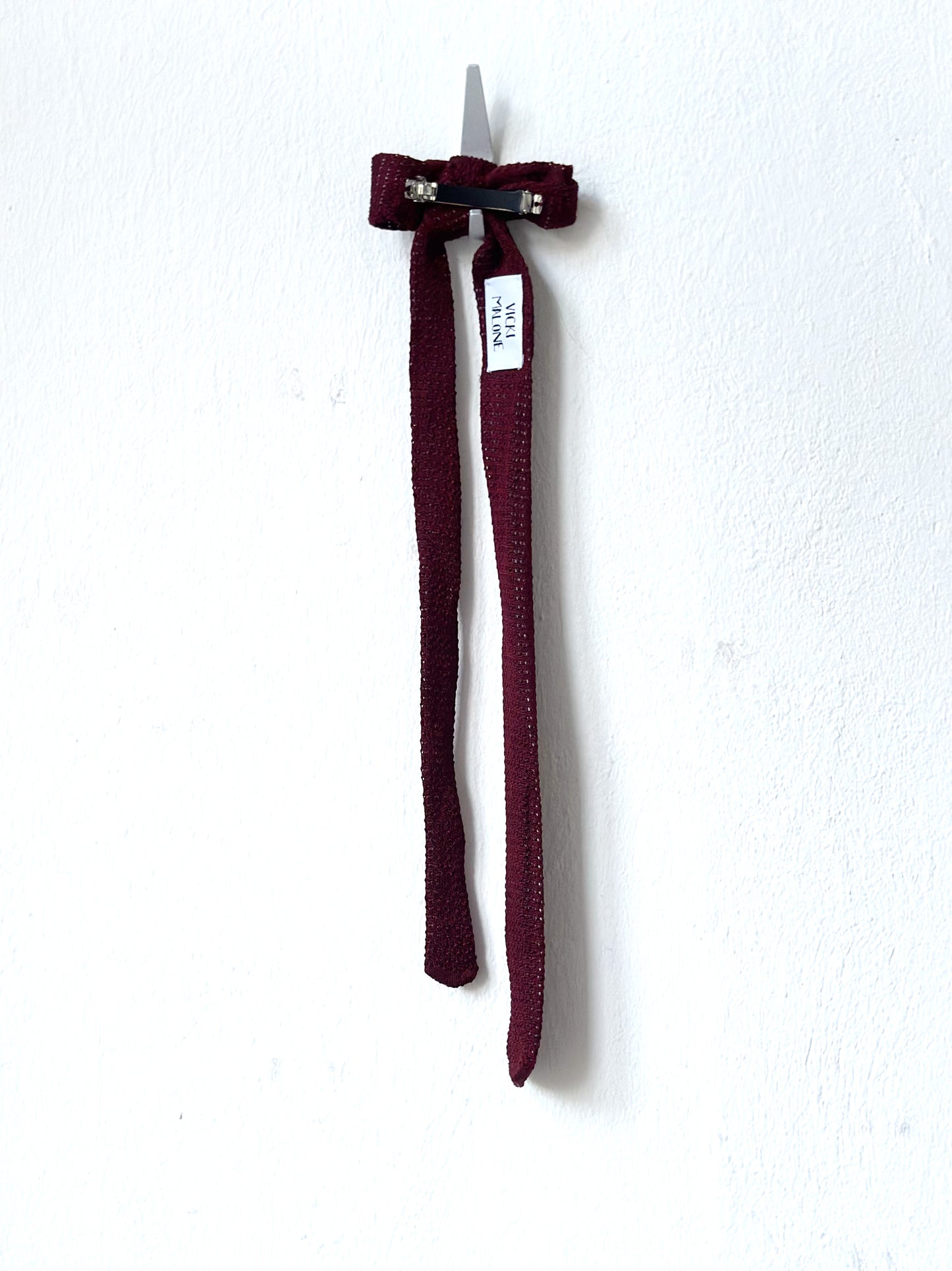 Maroon hair clip on a white background.