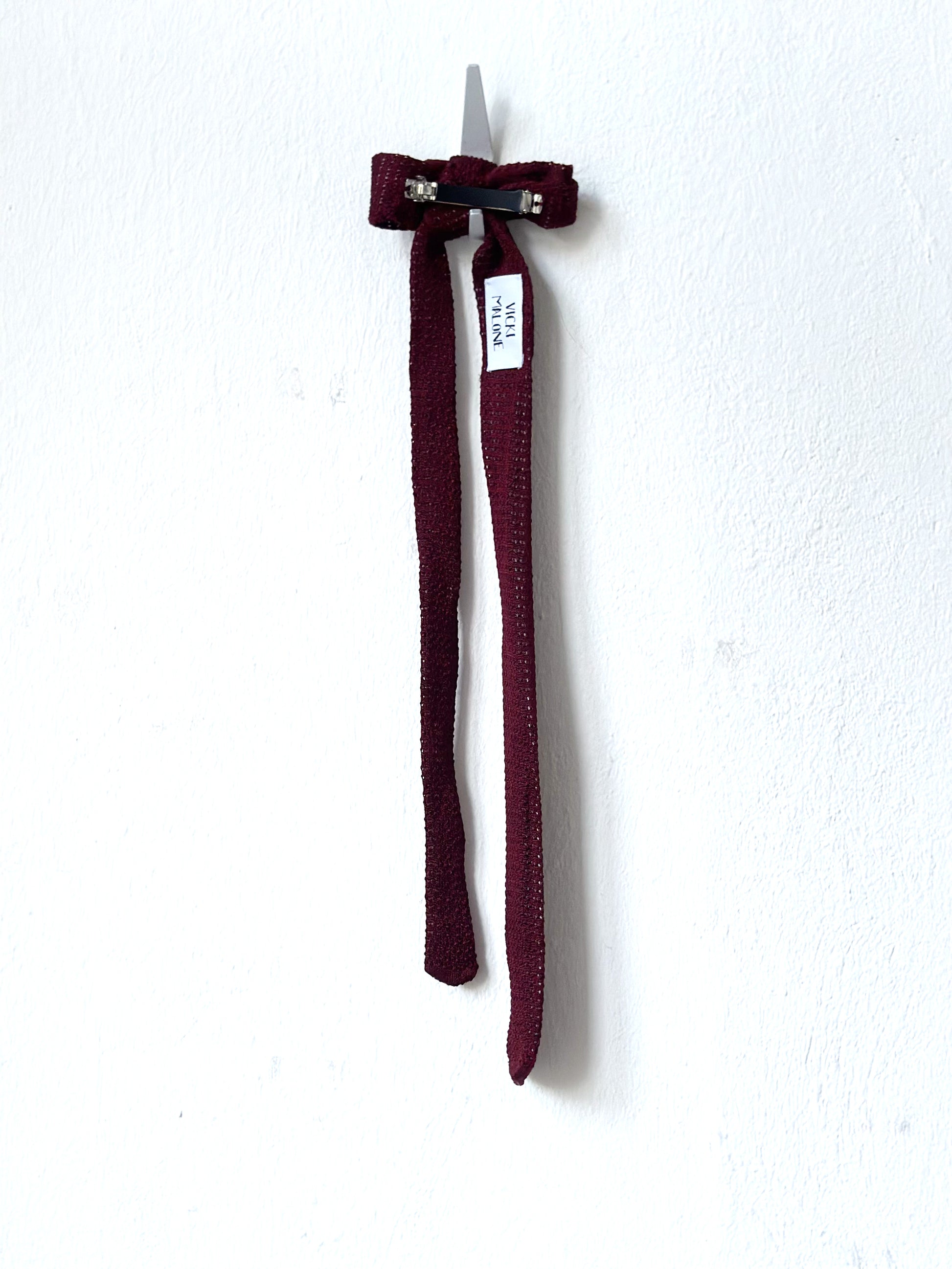 Maroon hair clip on a white background.