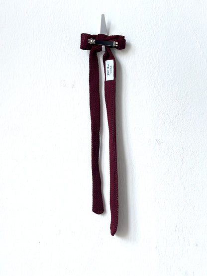 Maroon hair clip on a white background.