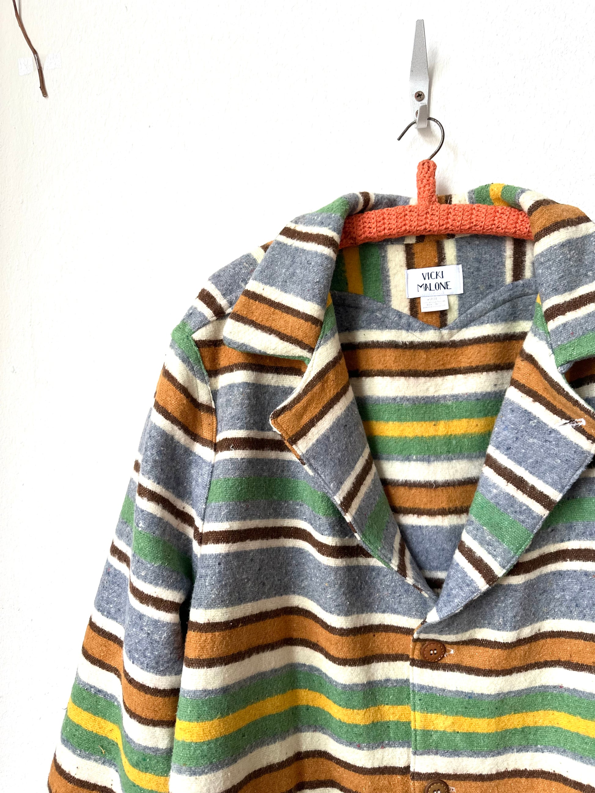 Striped jacket with a hanger on a white background