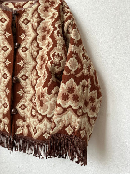 Brown and beige patterned fabric with fringes on a white background