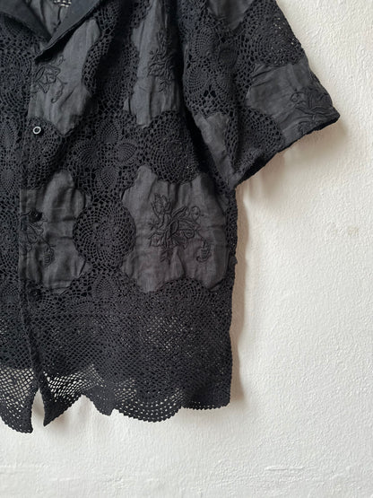 Black lace shirt on a white background.