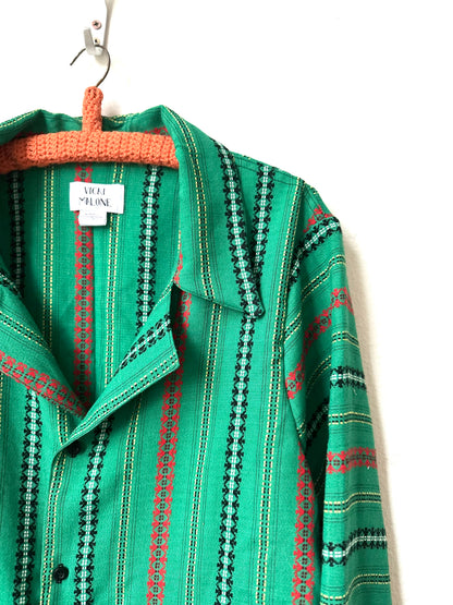 Green patterned shirt on a hanger with a visible brand tag.