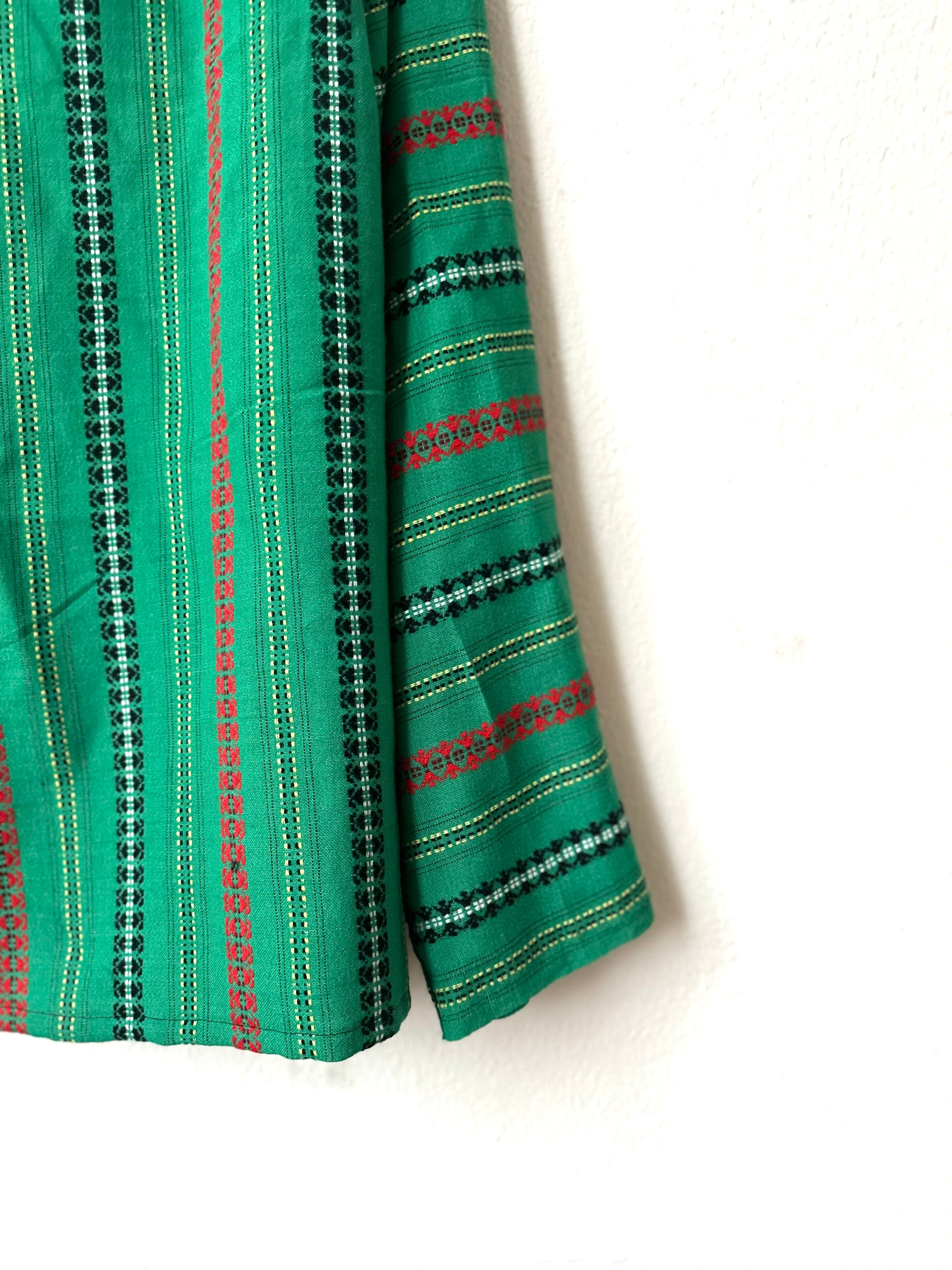 Green shirt with black and red stripes on a white background