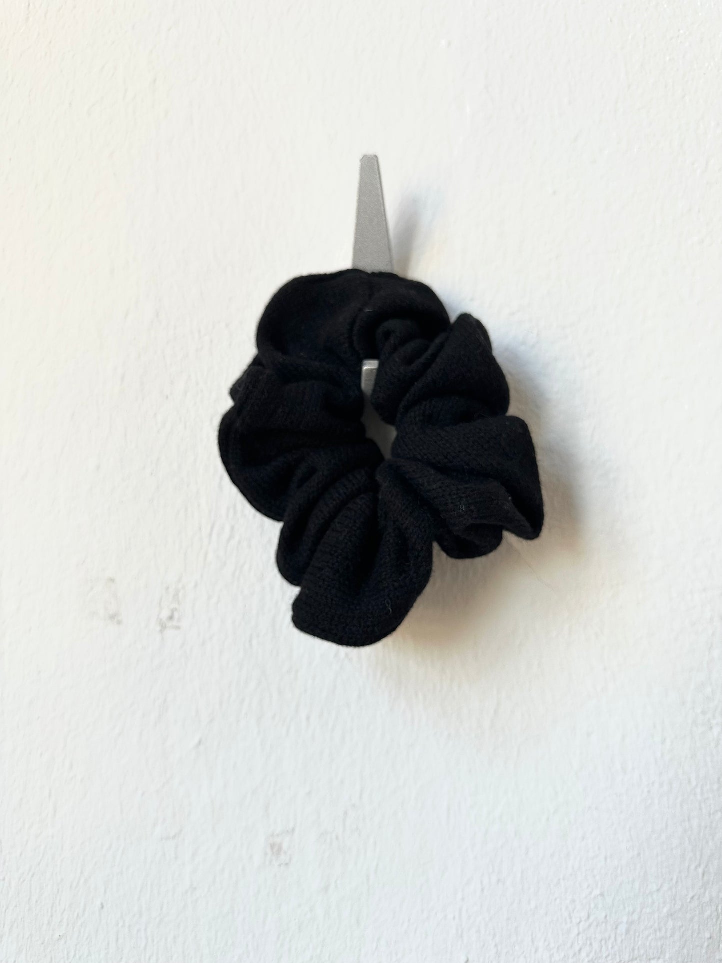 Black scrunchie on a white background
