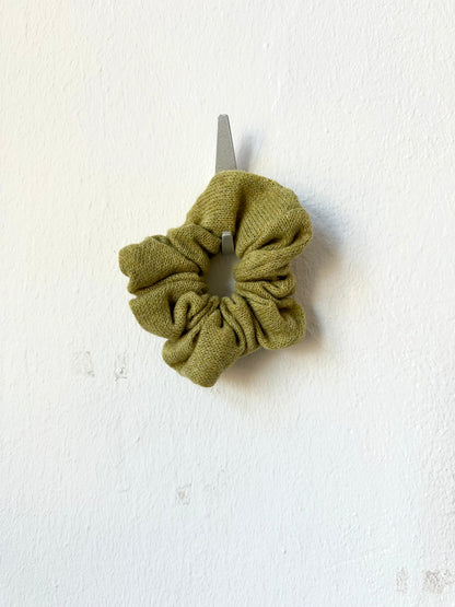 Green knitted scrunchie on a white background