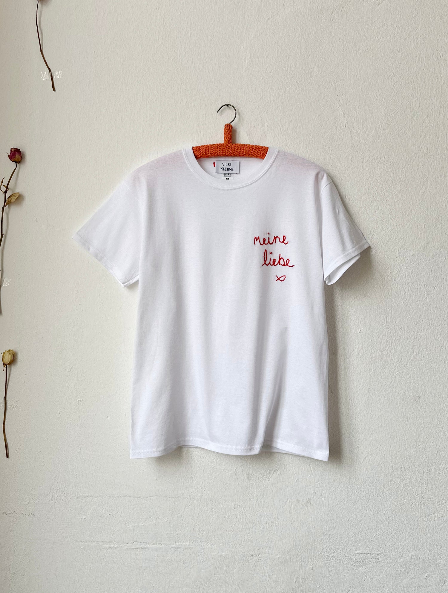 White t-shirt with 'Meine Liebe' embroidered in red, 100% cotton, classic silhouette, hand embroidered in Berlin.