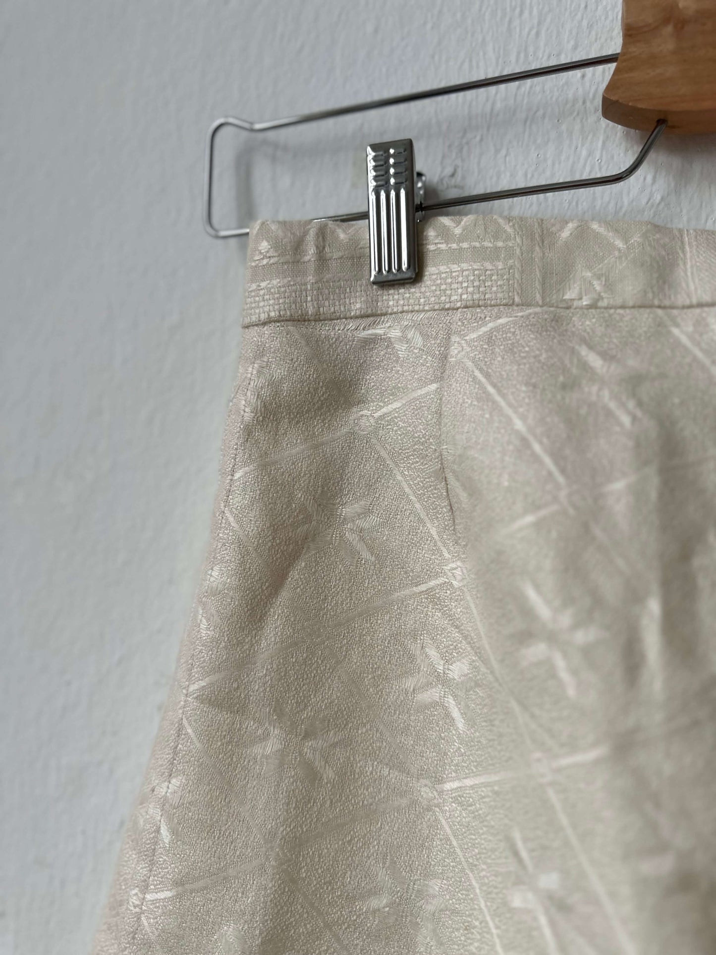 Detail view of trousers on a hanger.