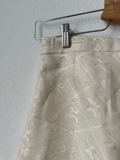 Detail view of trousers on a hanger.